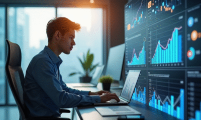 Jeune professionnel travaillant sur un ordinateur avec graphiques et icônes sociales